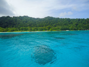 Scenic view of swimming pool by sea against sky