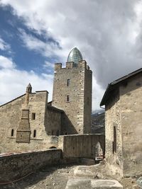 Low angle view of historic building against cloudy sky