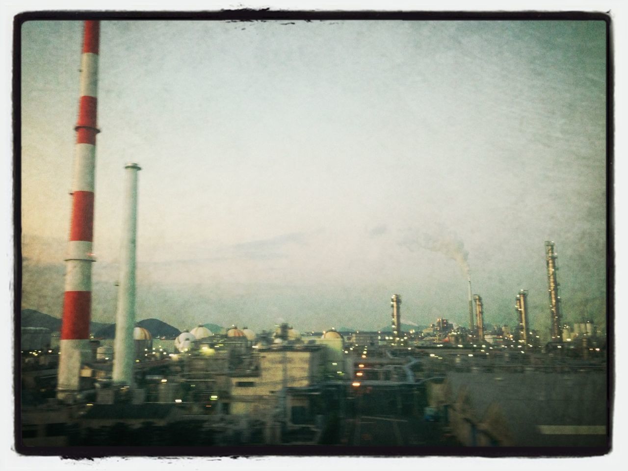 transfer print, auto post production filter, building exterior, architecture, built structure, city, sky, cityscape, industry, panoramic, factory, tower, development, crane - construction machinery, smoke stack, outdoors, tall - high, weather, no people, cloud - sky