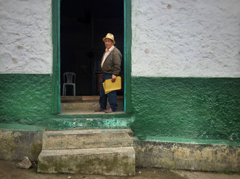 Man standing by door of building