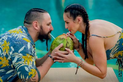 Young couple holding ice cream outdoors