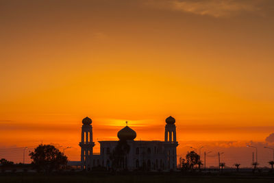 Silhouette building against sky during sunset