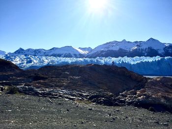 Scenic view of mountains against blue sky