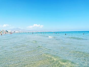 Scenic view of beach against blue sky