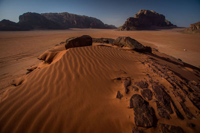 Sand dunes in desert against sky