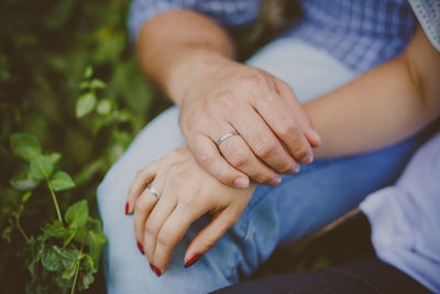 Close-up of couple holding hands