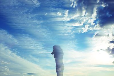 Low angle view of woman against sky