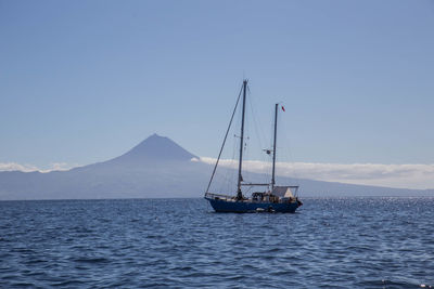 Sailboat on sea against sky