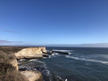 Scenic view of sea against clear blue sky