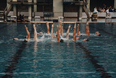 Group of people swimming in pool