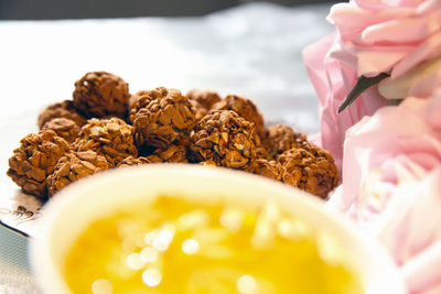 Close-up of granola balls with rose flowers