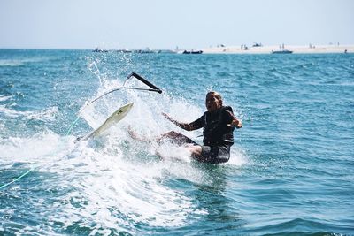 Man surfing on sea against sky