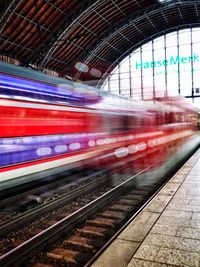 Blurred motion of train at railroad station