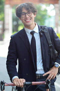 Portrait of businessman standing in city