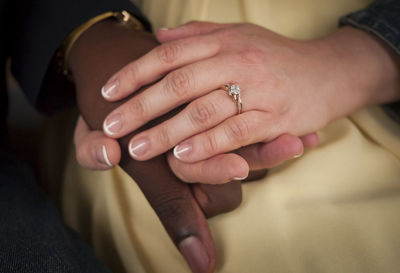 Cropped image of newlywed couple holding hands