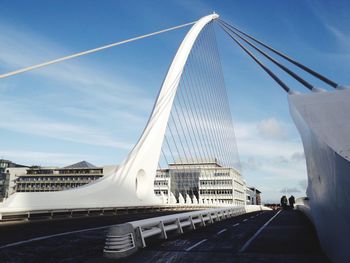 View of suspension bridge against cloudy sky