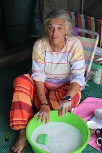 Midsection of woman sitting on table