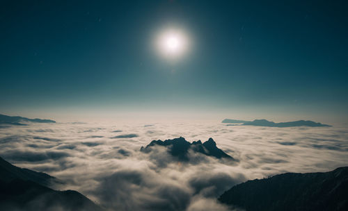 Scenic view of snowcapped mountains against sky at night