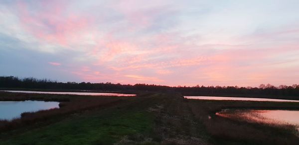 Scenic view of lake against sky during sunset