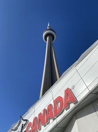 Low angle view of text on building against sky