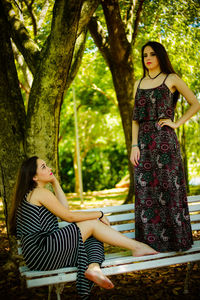Beautiful young women on bench at park