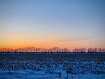 Scenic view of field against sky during sunset