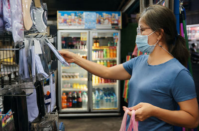 Full length of woman standing in store