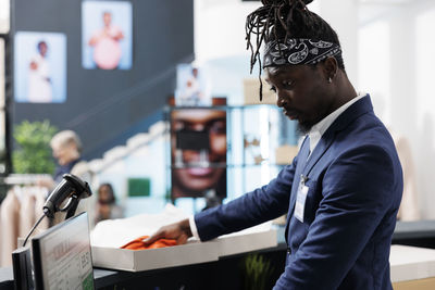 Side view of man working at table