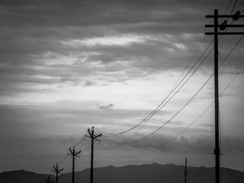 Low angle view of electricity pylon against sky