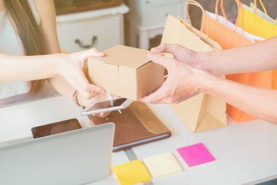 Close-up of women holding package