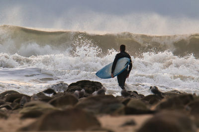 Rear view of man in sea