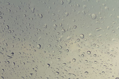 Full frame shot of raindrops on glass window