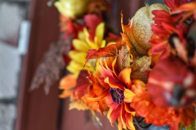 Close-up of orange flower on autumn wreath