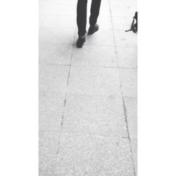 Low section of woman standing on tiled floor