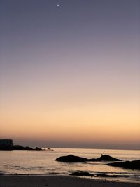 Scenic view of sea against clear sky during sunset