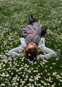 High angle view of woman resting on flowerbed