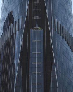 Low angle view of modern glass building in city