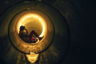 Man sitting in pipe