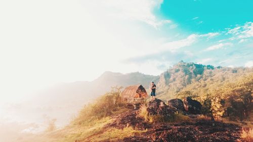 People on mountain against sky