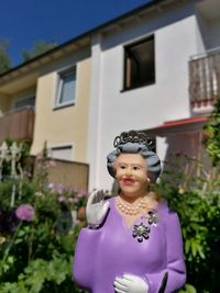 Close-up of smiling girl in yard against house