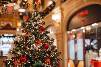 Red green festive christmas balls hanging on the christmas tree. new year's details