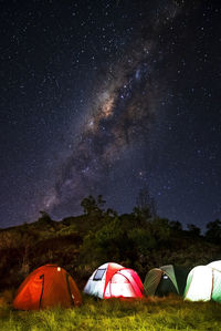 Tent on field against sky at night