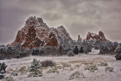 Rock formations on landscape against sky