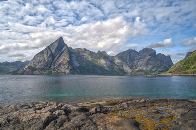 Scenic view of sea and mountains against sky