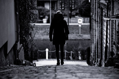 Surface level view of woman walking on footpath