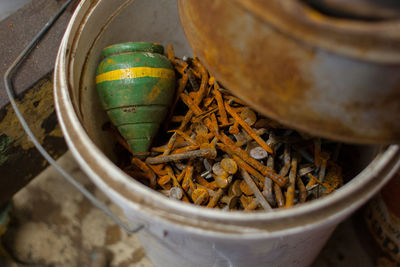 High angle view of rusty nails and in container