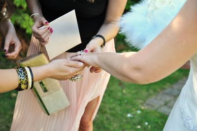 Friends admiring bride wedding ring