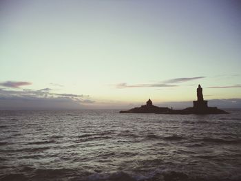 Silhouette boat sailing in sea against sky during sunset