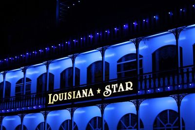 Low angle view of illuminated text at night