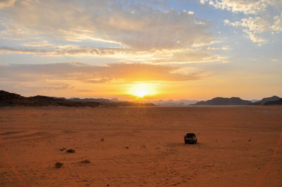 Scenic view of desert against sky during sunset